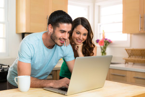 Husband and wife couple sharing a computer laptop social network