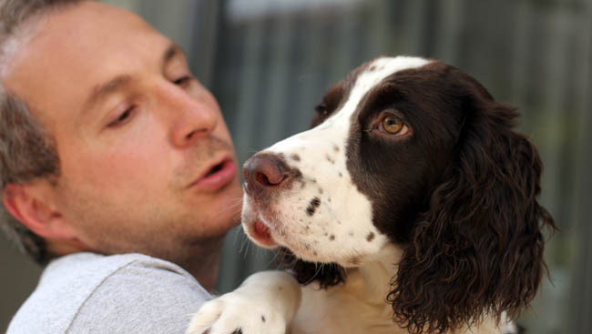 man holding his dog